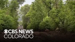 Floodwaters cover roads with mud in one Colorado county