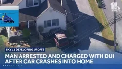Man arrested and charged with DUI after car crashes into home