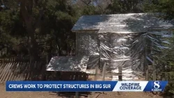 Firefighters wrap 1884 Pfieffer Homestead Cabin in fire-resistant material as wildfires burn